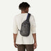 Patagonia Atom Sling Bag 8L in Smolder Blue, worn crossbody