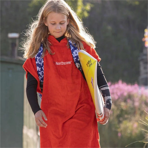 Child wearing the Northcore Kids Beach Basha changing robe with hood up