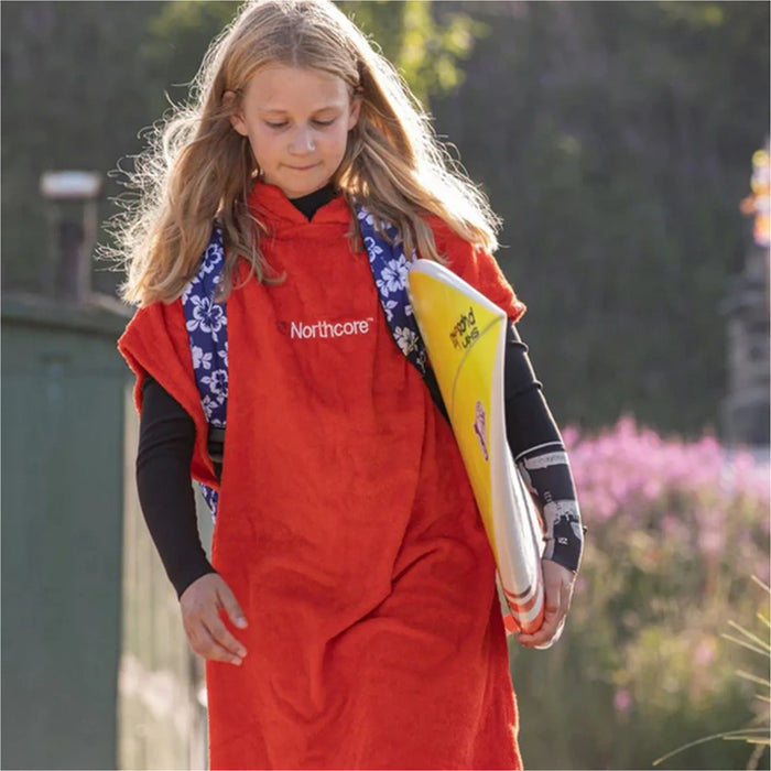 Child wearing the Northcore Kids Beach Basha changing robe with hood up
