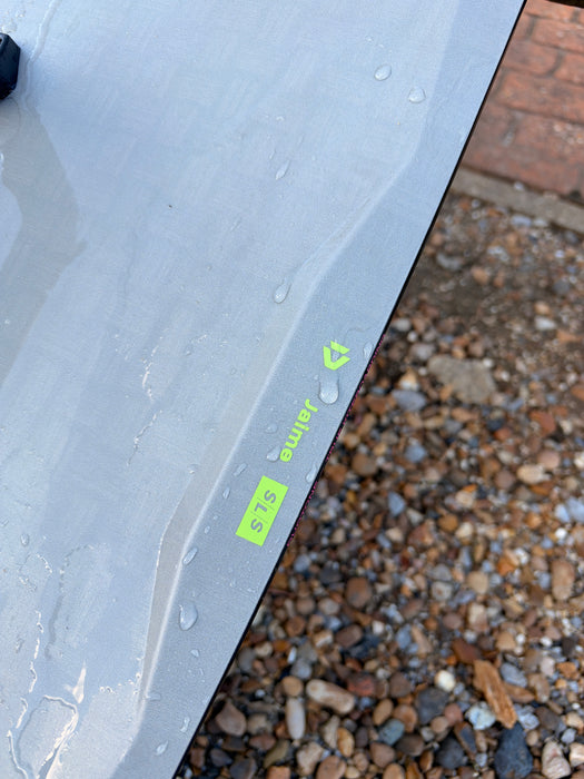 Used Duotone Jaime SLS 2027 kiteboard surface close-up showing faint sand scuffs