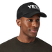 Man wearing the black Yeti Coolers Mid Pro Foam Trucker Hat