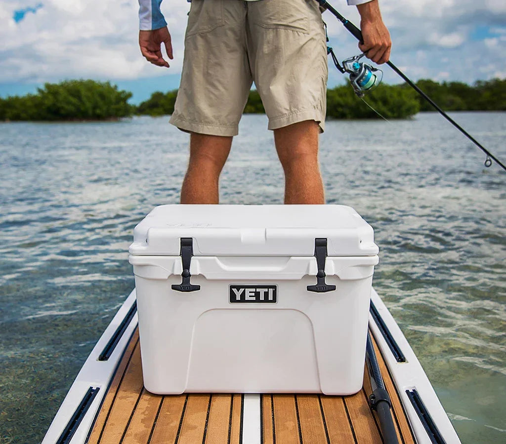 YETI Tundra 35 Hard Cooler on paddle board with person fishing on water