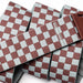 Arcade belt with burgundy and grey checkered pattern and brown buckle