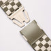 Arcade belt with khaki and white checkerboard pattern and plastic buckle close-up