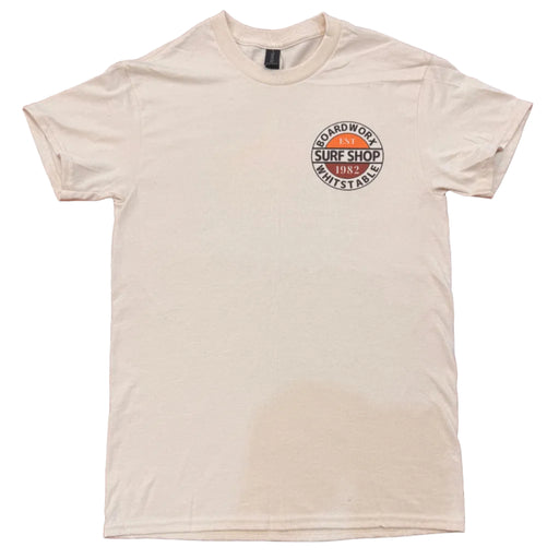 Board-Worx Surf Shop 1982 logo t-shirt in ivory white, flat lay on a wooden table