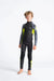 Boy wearing C-Skins Element 3/2 Junior wetsuit in black with yellow and grey accents
