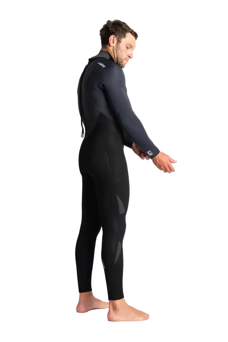 Man wearing C-Skins Legend 5:4:3 GBS back zip wetsuit in black, side view