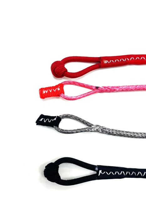 Core kite pigtails set in red, pink, grey, and black for kitesurfing rigging
