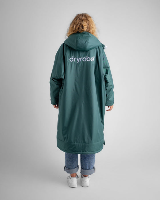 Woman wearing Dryrobe Advance Dark Green Grey outdoors