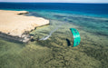 Duotone EVO SLS turquoise kitesurfing kite in action over clear coastal water