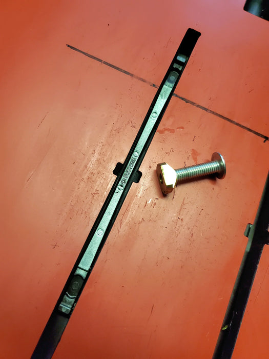 Duotone black wing foil track nut sled and bolt on an orange surface