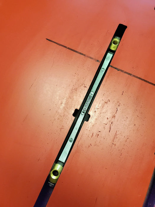 Duotone wing foil track nut sled with metal and brass inserts on an orange background