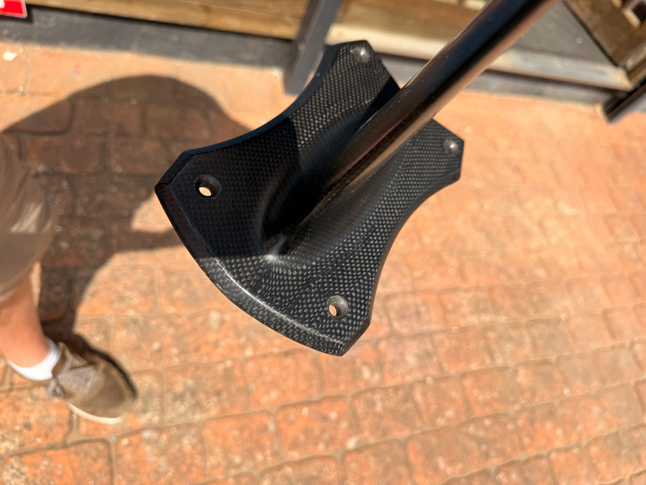 Angled view of used F-one Carbon Mast 85 board foot connection showing F-one lightning bolt logo and plate fitting holes