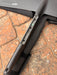Close-up of F-one Eagle 1290 Titan connection plate showing hardware detail and protective carry bag