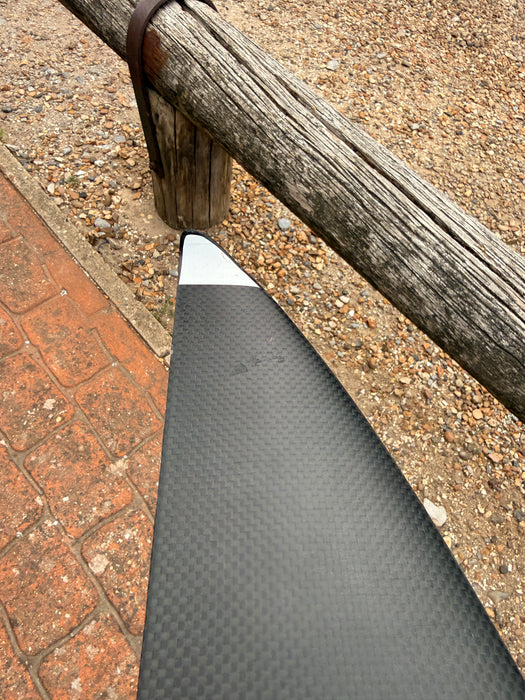 Close-up of left wingtip of used F-one Eagle 1290 HM Carbon showing small surface scuffs near the white leading edge tip