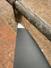 Close-up of left wingtip of used F-one Eagle 1290 HM Carbon showing small surface scuffs near the white leading edge tip