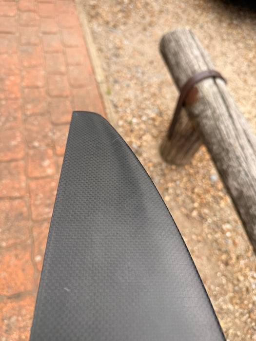Close-up of wingtip underside of used F-one Eagle 1290 HM Carbon front wing showing clean carbon surface