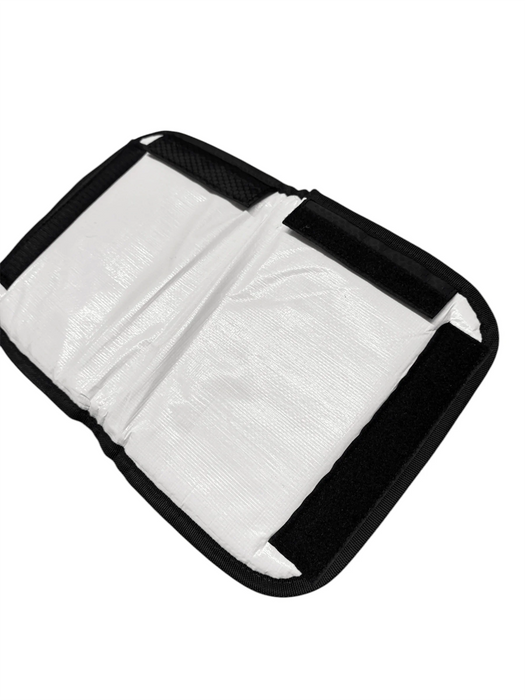 White and black shoulder saver carry pad for watersports equipment with Velcro straps