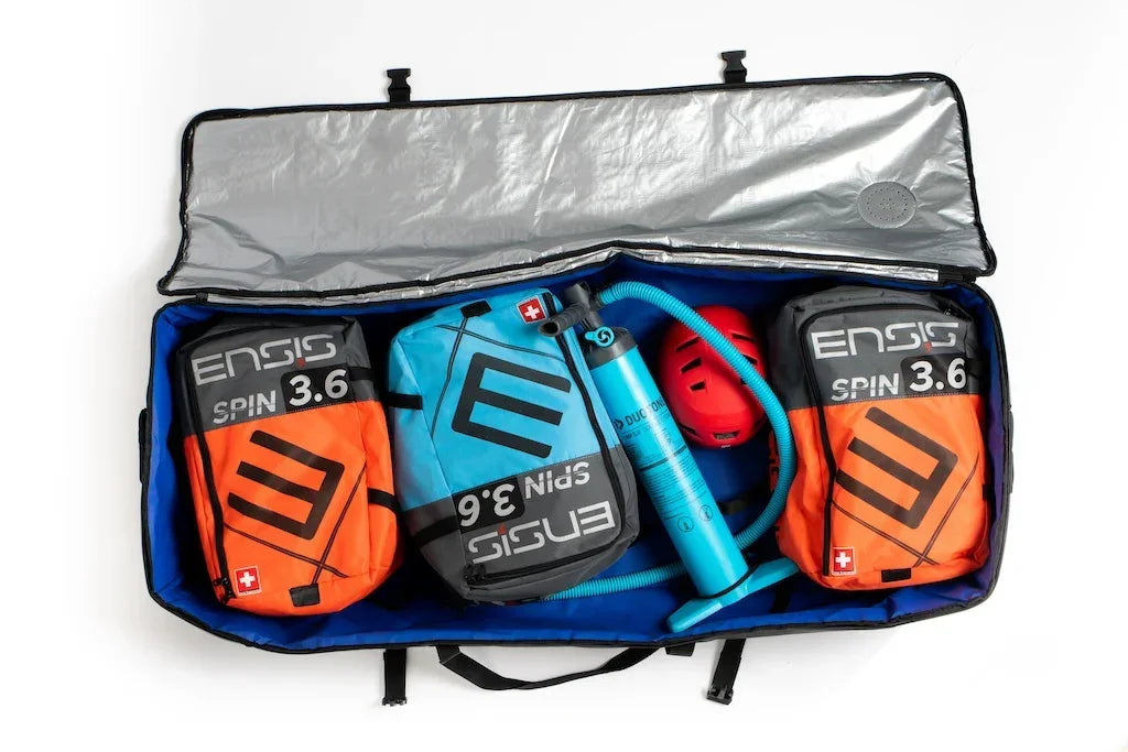 ENSIS Spin 3.6 wing foils in orange and blue bags, pump, and helmet in large quiver bag
