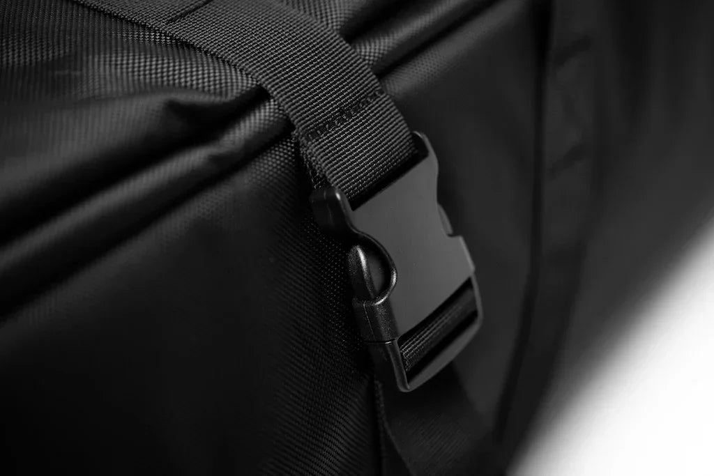 Close-up of black wing foil board bag buckle and strap, durable watersports gear