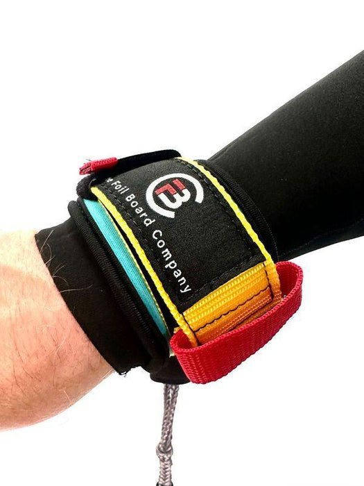 Foil Board Company wrist wing foil leash with black, yellow, and red strap detail