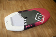 mb boards Albatros 118L wingfoil board, white and pink with grey deck, on wood floor