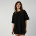 Mystic black oversized t-shirt for watersports, white logo on chest, worn by female model