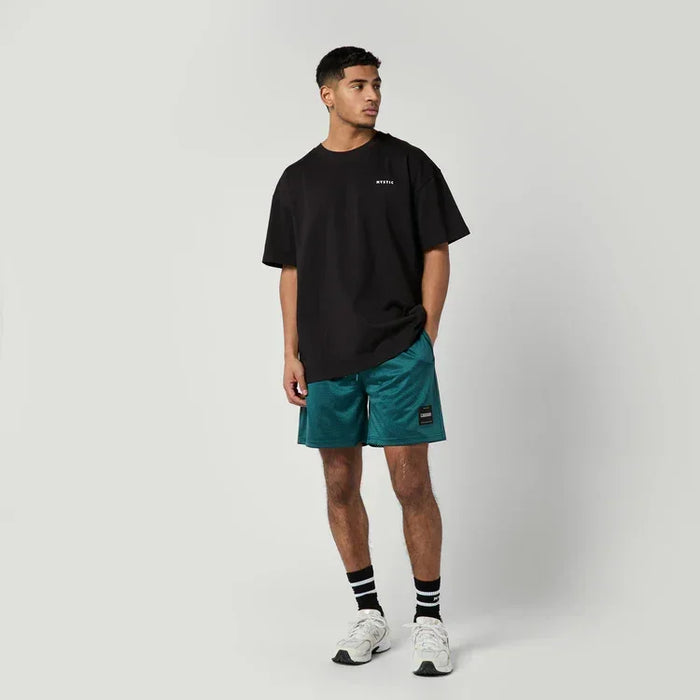 Mystic black profile tee with chest logo, worn with teal board shorts, watersports clothing