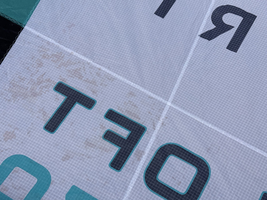 Close-up of cosmetic colour bleed staining on the white canopy of the used North Loft Pro wing