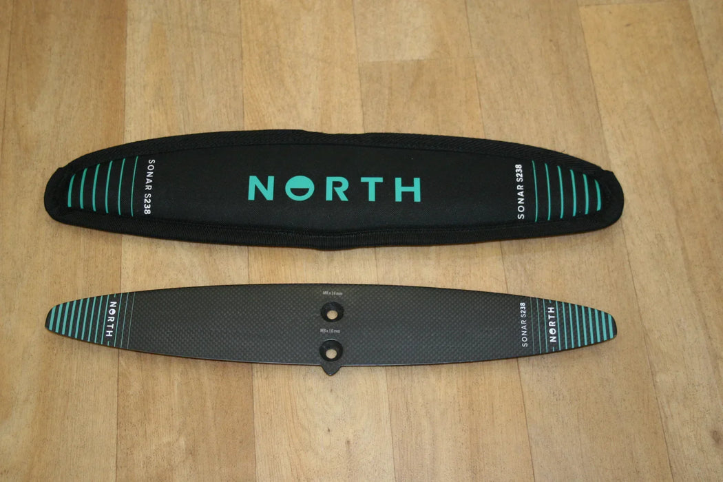 North Sonar S238 carbon stabilizer for wing foiling with black cover on wood floor