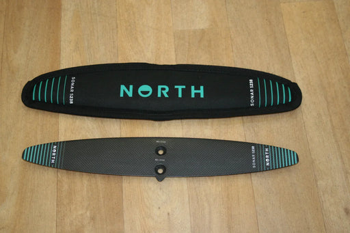 North Sonar S238 carbon stabilizer for wing foiling with black cover on wood floor