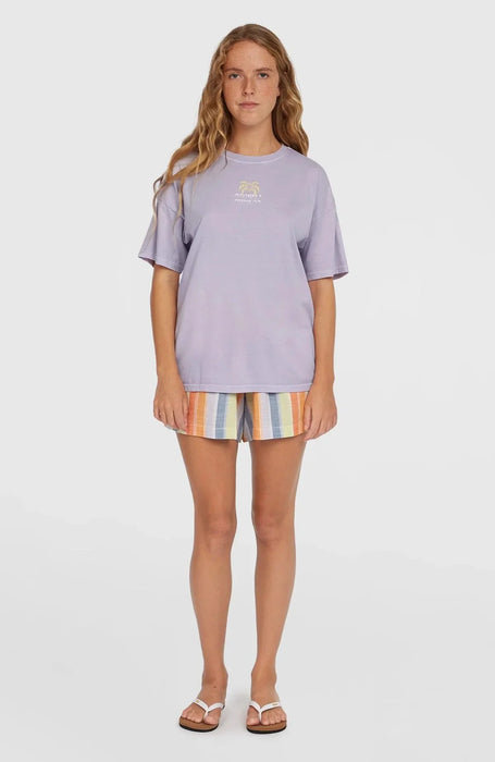 O'Neill vintage beach tee in purple with palm tree graphic, worn by woman in striped shorts
