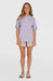 O'Neill vintage beach tee in purple with palm tree graphic, worn by woman in striped shorts