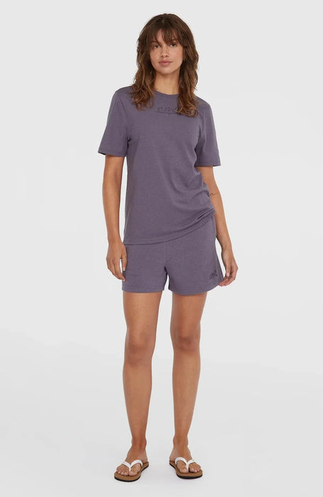 Woman wearing O'Neill Essentials purple sweatshorts and matching t-shirt, casual surf clothing