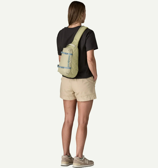 Patagonia Atom Sling 8L weathered stone bag worn by woman, outdoor clothing