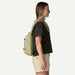 Patagonia Atom Sling Bag 8L in weathered stone worn by person, side view
