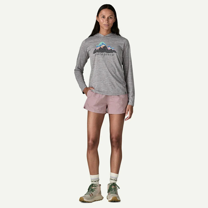 Woman wearing Patagonia barely baggies shorts in quiet violet and a grey Patagonia long sleeve top