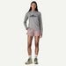 Woman wearing Patagonia barely baggies shorts in quiet violet and a grey Patagonia long sleeve top