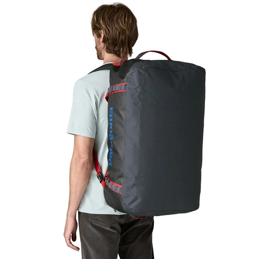 Person wearing a black backpack with visible branding on a white background