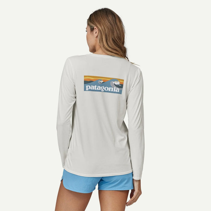 Patagonia long-sleeved white graphic watersports shirt with logo, worn by woman
