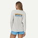 Patagonia long-sleeved white graphic watersports shirt with logo, worn by woman