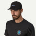 Patagonia black cap with P-6 label on man, surf t-shirt, surf clothing accessory