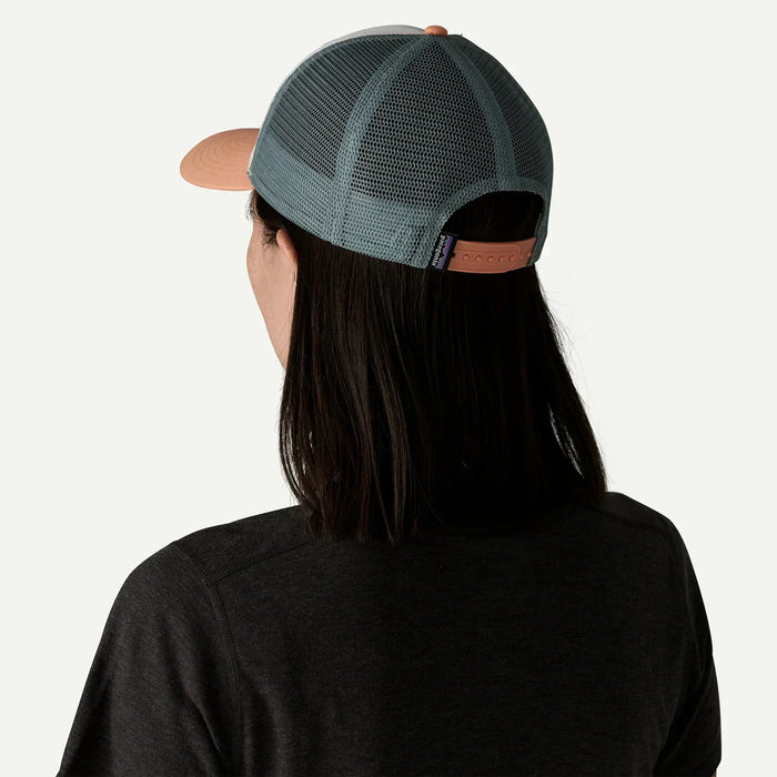 Patagonia P-6 Logo trucker hat with peach brim and grey mesh back, shown from behind