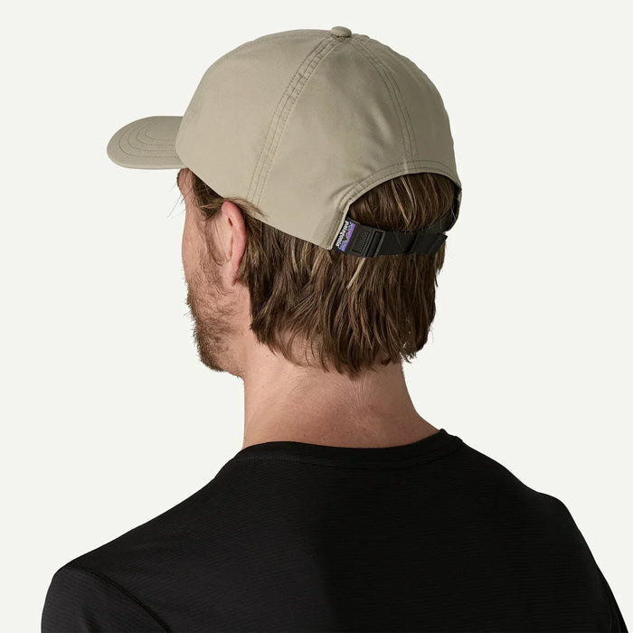 Patagonia Terrebonne khaki cap with adjustable strap, worn by man in black shirt