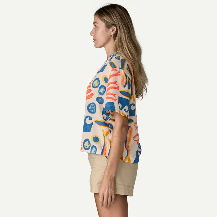 Patagonia tidal threads shirt with sardine print in natural cream, worn by woman in beige shorts