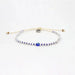 Blue and white beaded anklet with adjustable cord and central evil eye charm