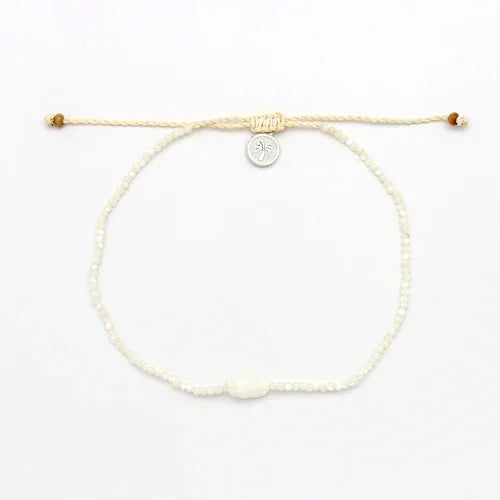 Giada Melati shell bead anklet with white adjustable cord and round metal charm on white background