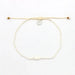 Giada Melati shell bead anklet with white adjustable cord and round metal charm on white background