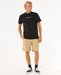 Rip Curl black t-shirt with colourful logo, worn by man in beige shorts, surf clothing