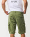 Rip Curl mid green cargo shorts with flap pockets, shown from the back on a model